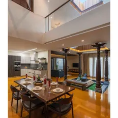 A large skylight is positioned directly above the central courtyard in the "Between Two Trees" house. This feature ensures that the core of the home is always bright, connecting the inhabitants to the sky above.