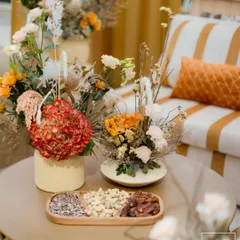 Details from our 'Markets of the Middle East' theme in Doha. A tray of dates and nuts sits beside dried floral arrangements, reflecting the earthy and authentic vibe of a traditional souq.