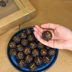A closer look at my Belgian Chocolate Orange Ladoos. These vegan and gluten-free energy balls are made with Medjool dates and raw ingredients, offering a nutritious and protein-rich snack.