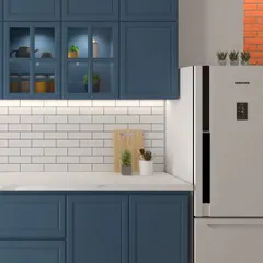A look at our shaker-style kitchen, where deep blue cabinets are paired with a classic white subway tile backsplash. The glass-front upper cabinets with interior lighting are perfect for displaying your favorite dinnerware.