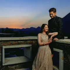 A breathtaking sunset shot from a rooftop in Udaipur, with the couple sharing a moment as the sky turns into a beautiful canvas of colors.