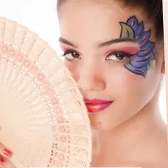 Editorial work allows for more creativity. This is an example of an artistic makeup look, featuring bold face paint and dramatic eyes, perfect for fashion photoshoots that require a unique and expressive style.
