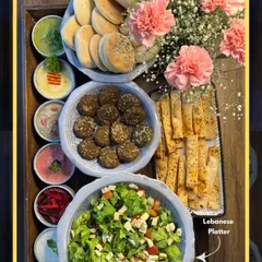 This Lebanese-inspired platter is a feast for the eyes and the palate. It's generously packed with falafel, pita, salads, and a rainbow of dips, beautifully decorated with fresh flowers.