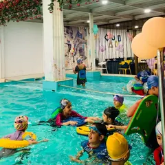 Kids having a blast during a pool party. With floaties, kickboards, and a warm pool, it's the perfect recipe for a memorable celebration.