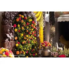 A close-up of the intricate floral work on the Prabhavali, where bursts of colourful flowers are set against a bed of lush greenery. This detail showcases our skill in creating beautiful, textured floral backdrops.