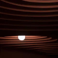 A detail from our award-winning 'Whispers in Motion' project. The dramatic, layered ceiling is sculpted to create a sense of rhythm and depth, with a single light source emerging like a pearl from within the form.