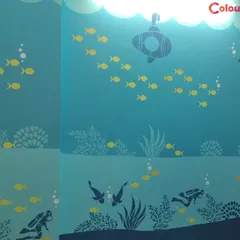 We created an enchanting underwater world in this kids' room. The multi-toned blue wall features stencils of fish, a submarine, and scuba divers, turning the entire room into an aquatic adventure.