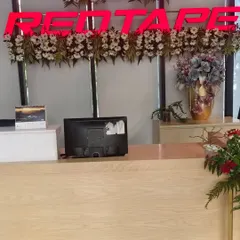 Here, I decorated the main reception area for the RedTape office. I placed fresh floral arrangements directly below the company logo to reinforce the brand identity right at the entrance.