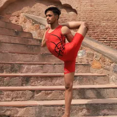 Yoga is a path of continuous growth. Here, a student demonstrates a standing backbend variation, a testament to the strength and discipline we cultivate in our advanced classes.