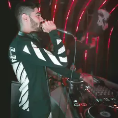 On the mic, interacting directly with the partygoers. This is how I turn a DJ set into a shared experience, making sure everyone feels like part of the show.