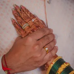 A symbolic close-up of the couple's hands after the ring ceremony. This shot beautifully displays the engagement rings and the bride's intricate mehndi, representing their new commitment.