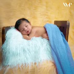 We use a variety of simple, safe props like this tiny bed to add a touch of charm to our newborn portraits. The focus always remains on the peaceful, sleeping baby.