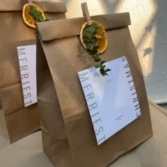 Our custom Christmas gift bags, ready to be filled. I love adding little touches like a dried orange slice and a sprig of eucalyptus to make each one feel special.