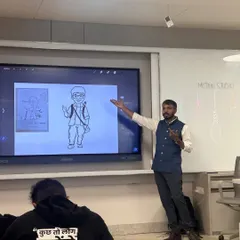 In my hands-on mascot design workshops, I use digital tools to teach character development. This image shows me presenting a complete mascot concept to B.Des students, explaining how each attribute contributes to the character's personality and story.