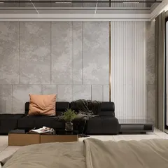 This bedroom design features a concrete-finish wall panel and a glass-fronted wardrobe, creating a modern and slightly industrial feel. A comfortable L-shaped sofa provides a perfect spot for lounging.