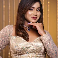 A close-up of a modern party look. The makeup features a soft smokey eye, contoured cheeks, and a matte mauve lip, paired with a stunning diamond and sapphire necklace.