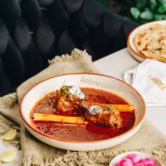 My Lamb Nalli Nihari, slow-cooked for hours to achieve a melt-in-your-mouth texture. Served with bone marrow, it's a true taste of Old Delhi's culinary heritage.