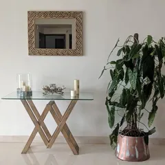 A tall Philodendron plant in a copper planter adds a touch of organic elegance to this entryway console. I help select indoor plants that fit the scale and style of your home decor.