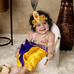 This is one of my most popular shoots, the Janmashtami special. I bring the entire setup, including the costume, props, and backdrop, to your home so your little Krishna can have his moment without any fuss.
