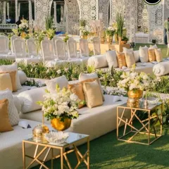 An elegant and luxurious outdoor seating arrangement in pristine white and gold. I believe guest comfort is key, and I design beautiful lounge areas where your loved ones can relax and celebrate in style.
