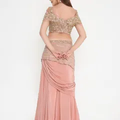 This peach draped gown features a fully hand-worked off-shoulder blouse with moti and cut danas. The fit is completely customized to the client's choice.