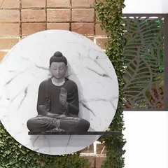 A close-up of a serene Buddha statue set against a circular marble backdrop and a vertical garden. This is a perfect feature for creating a calm entryway or courtyard.