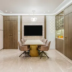 The dining area is centered around a stunning Onyx table and comfortable swivel chairs. The 3D patterned accent wall behind the TV adds depth, while the built-in crockery unit with a bar nook offers elegant storage and serving space.