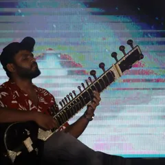 A close-up from a contemporary music festival. The modern shirt and cap are part of the casual, accessible vibe I bring to my fusion performances.