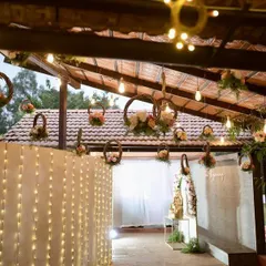 The entrance to this reception featured a stunning blend of luxury and nature, with grand crystal lights, a lush flower wall, and hanging floral baskets creating an unforgettable first impression.