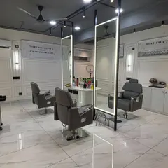 The main styling area features custom-made stations with integrated profile lighting in the mirrors. We used a combination of track lights and wall sconces against the French moulding to create layered, adjustable lighting perfect for hair services.