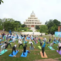 Experience the collective energy of practicing yoga together at our international center in Bengaluru. This image from an International Day of Yoga celebration shows hundreds of people finding harmony in body and mind against the backdrop of our iconic Vishalakshi Mantap.