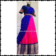 A full-length view of the royal blue and pink Langa Voni. The skirt has a traditional gold border, and the blouse sleeves feature beautiful paisley embroidery.