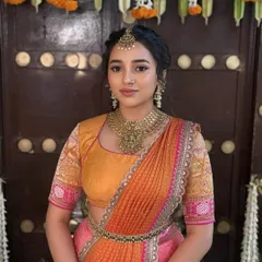 The timeless charm of a South Indian pre-wedding ceremony. This look is all about simplicity and elegance, with glowing skin and traditional jewellery for a beautiful half-saree look.