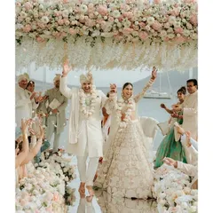 A joyous moment as the couple celebrates their union under a canopy of flowers in Bodrum, Turkey. Our destination wedding service ensures that even miles away from home, every tradition is honoured with elegance and authenticity, against a stunning seaside backdrop.
