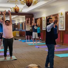 Guiding office employees through simple standing yoga poses they can do anywhere.