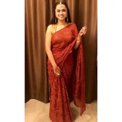 The classic red saree is a staple for Indian festive wear. Its fluid fabric drapes beautifully, creating an elegant and elongated silhouette perfect for making a graceful entrance.