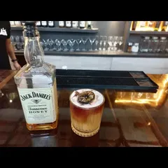 A classic whiskey sour made with Jack Daniel's Honey, garnished with a dehydrated lemon wheel. A perfect balance of sweet, sour, and strong.