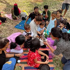 Another angle of the children captivated by the hand puppet. This kind of tactile interaction makes the storytelling experience more memorable and fun for toddlers and young kids.