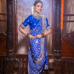 A full-length view of the royal blue Navari saree. The makeup and hair were styled to create a look of complete traditional grace, perfect for a classic Marathi wedding.