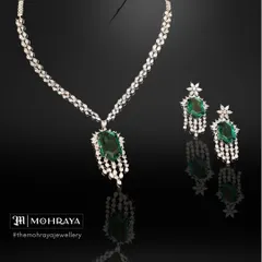 An elegant emerald and diamond necklace set, perfect for a sophisticated reception or cocktail party look. The classic design is timeless and available for rent.