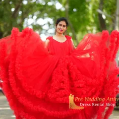 My collection includes high-fashion pieces like this vibrant red ruffled gown. The layers of soft tulle create incredible volume and texture, adding a sense of movement and playfulness to your photos. It's a fantastic choice if you want your outfit to be fun and memorable.