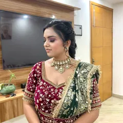 This side profile highlights the braided hairstyle and the flawless blend of the eyeshadow. The contouring defines her features while maintaining a soft, bridal glow.