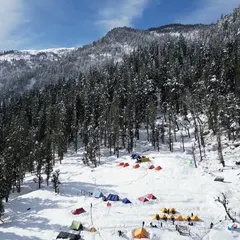 Our campsite for the Kedarkantha trek, set in a clearing surrounded by snow-laden pine forests. It's a scene straight out of a dream.