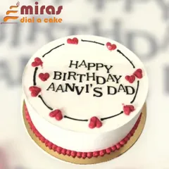A simple and sweet birthday cake for "Aanvi's Dad." The white cake is decorated with a border of red hearts, showing that a heartfelt message is sometimes the best theme of all.