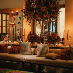 I believe the right ambiance is crucial to the dining experience. Here, I used towering floral arrangements, candelabras, and warm, layered lighting to create an intimate and luxurious setting for an evening event.