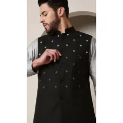 A close-up of the 'Shoorveer' bandi jacket in black, featuring delicate silver embroidery. This piece is designed to be layered over the grey silver kurta for a look of sharp contrast.
