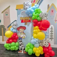 Howdy partner! A fun and colorful Toy Story theme for Rori's 3rd birthday, featuring Jessie, a custom backdrop, and balloons in the iconic red, yellow, blue, and cow-print pattern.