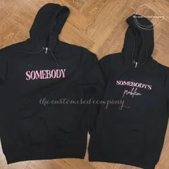 A playful take on couple's apparel, these matching black hoodies read "Somebody" and "Somebody's Problem." It's a fun and cheeky gift for couples who share a great sense of humor.