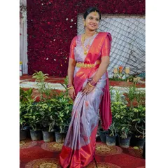 A full view of the client, showing how the simple makeup and elegant hairstyle work together with her beautiful saree for a complete wedding guest look.
