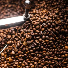A close-up of coffee beans in a roaster. This kind of detailed, textural shot is great for brands that want to tell the story of their process.